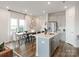Bright, open kitchen featuring stainless steel appliances, eat-in island, and adjacent dining area at 5006 Kellaher Pl, Charlotte, NC 28216