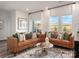 Elegant living room featuring leather seating, modern rug, and sliding glass door at 5006 Kellaher Pl, Charlotte, NC 28216