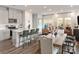 Open concept kitchen and living room area, with a breakfast bar, stainless steel appliances and modern design at 5006 Kellaher Pl, Charlotte, NC 28216