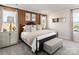 This spacious main bedroom has decoratively papered accent wall, a comfy bed, and large picture windows at 5006 Kellaher Pl, Charlotte, NC 28216