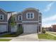 New townhome with a two-car garage, sidewalk, and fresh landscaping at 5030 Kellaher Pl, Charlotte, NC 28216