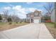 Charming two-story home features a long driveway and an attached garage at 610 John St, Monroe, NC 28110