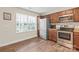 Well-lit kitchen featuring stainless steel appliances, wood cabinets, and durable wood flooring at 610 John St, Monroe, NC 28110