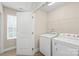 Well-lit laundry room with full-size washer and dryer at 610 John St, Monroe, NC 28110
