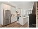 Bright, open kitchen featuring an island, stainless steel appliances, white cabinetry, and modern fixtures at 619 W Tremont Ave, Charlotte, NC 28203