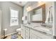 Bright bathroom with granite countertops, double sink vanity, framed mirror and window at 658 Quicksilver Trl, Fort Mill, SC 29708