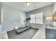 Well lit bedroom converted to home gym with treadmill, window, and wall mounted TV at 658 Quicksilver Trl, Fort Mill, SC 29708