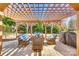 Inviting outdoor space with a wooden pergola and comfortable seating area for relaxing and entertaining at 658 Quicksilver Trl, Fort Mill, SC 29708