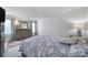 Bedroom with a large bed featuring a patterned comforter, a wooden dresser with a mirror, and bright natural light at 6815 Cabot Cir, Charlotte, NC 28226