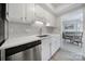 Clean kitchen with white cabinetry, subway tile backsplash, and stainless steel dishwasher at 6815 Cabot Cir, Charlotte, NC 28226