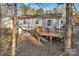 Backyard view featuring a house, wooden deck, and mature trees at 708 S 10Th St, Bessemer City, NC 28016