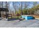 Backyard oasis featuring a deck, hot tub, and mature trees at 7209 Kilcullen Dr, Charlotte, NC 28270