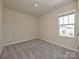 Well-lit bedroom with plush carpeting, neutral paint, and a large window offering natural light at 837 Blue Canyon Dr, York, SC 29745