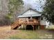 Back of house with deck and wooded lot at 925 Roosevelt St, Badin, NC 28009