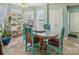 Bright dining room with colorful decor, light tile flooring, and natural light from the windows at 10422 Baskerville Ave, Charlotte, NC 28269