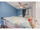 Bright bedroom with a blue accent wall, ceiling fan, and natural light creating a cozy atmosphere at 1148 Rita Ave, Statesville, NC 28677