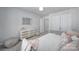 Bright bedroom featuring a rattan dresser, neutral color palette, and ample closet space at 116 Briana Marie Way, Indian Trail, NC 28079
