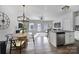 Inviting dining area with modern lighting, breakfast bar, stainless steel appliances, and a view to the backyard at 116 Briana Marie Way, Indian Trail, NC 28079