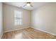 A simple, bright bedroom with wood floors and a window providing natural light at 121 Easter Ln, Davidson, NC 28036