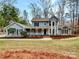 Charming two-story home with a welcoming front porch and beautiful landscaping at 14147 Maple Hollow Ln, Mint Hill, NC 28227