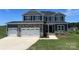 Charming two-story home featuring a stone facade, three-car garage, and manicured lawn against a bright sky at 1459 Mocksville Hwy # 19, Statesville, NC 28625