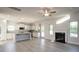Bright open-concept living room with white cabinets, gray backsplash, fireplace, and stainless steel appliances at 1459 Mocksville Hwy # 19, Statesville, NC 28625