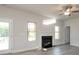 Spacious living room with a fireplace, ceiling fan, and light streaming through two adjacent windows at 1459 Mocksville Hwy # 19, Statesville, NC 28625