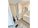 Bathroom showcasing a toilet, vanity, and round mirror at 1718 Fallston Rd, Shelby, NC 28150