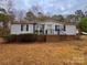 Quaint single-story home featuring brick-lined steps, complemented by a manicured lawn and mature trees at 1718 Fallston Rd, Shelby, NC 28150