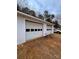 Detached garage with two bays, and white paneled doors at 1718 Fallston Rd, Shelby, NC 28150
