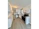 Well-lit kitchen featuring white cabinets, stainless steel appliances, and modern countertops at 1718 Fallston Rd, Shelby, NC 28150