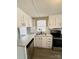 Updated kitchen boasts white cabinetry, stainless steel appliances, and gray countertops at 1718 Fallston Rd, Shelby, NC 28150