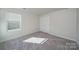 The bedroom boasts soft carpeting and neutral tones with a window view at 1735 Braemar Village Dr, Monroe, NC 28110