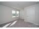 Neutral bedroom with large window providing natural light, and closet for storage at 1735 Braemar Village Dr, Monroe, NC 28110