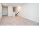 A spacious bonus room is carpeted and offers flexible living space at 1735 Braemar Village Dr, Monroe, NC 28110