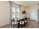 Dining room featuring wood floors, modern lighting, and large windows at 1735 Braemar Village Dr, Monroe, NC 28110