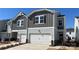 Charming two-story home with attached garage, modern siding, and manicured front lawn in a cozy neighborhood at 1735 Braemar Village Dr, Monroe, NC 28110
