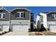 View of a modern two-story home featuring attached garage, modern siding, and well-maintained landscaping at 1735 Braemar Village Dr, Monroe, NC 28110