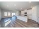 A modern, open-concept kitchen features white cabinets and stainless steel appliances at 1735 Braemar Village Dr, Monroe, NC 28110