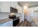 The kitchen showcases stainless steel appliances, granite countertops, and ample cabinet space at 1735 Braemar Village Dr, Monroe, NC 28110
