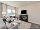Living room featuring modern decor, stylish furniture, and large windows at 1735 Braemar Village Dr, Monroe, NC 28110