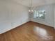 Dining room boasts hardwood floors, wainscoting, and a chandelier at 1805 Palazzo Dr, Waxhaw, NC 28173