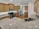 Well-lit kitchen with stainless steel appliances, granite countertops, and ample cabinet space at 1805 Palazzo Dr, Waxhaw, NC 28173