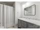 Bright bathroom featuring a gray vanity with marble countertop and framed mirror at 1836 Danny Ct, Matthews, NC 28105