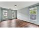 Bedroom with 3 windows to provide natural light and beautiful dark-stained floors at 1836 Danny Ct, Matthews, NC 28105