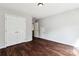 Bedroom featuring dark wood floors, large closet, and a neutral wall paint at 1836 Danny Ct, Matthews, NC 28105