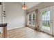 Bright dining area with hardwood floors, large windows, and access to the backyard at 1836 Danny Ct, Matthews, NC 28105