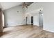 Open floor plan living room with wood floors, vaulted ceilings, and a ceiling fan at 1836 Danny Ct, Matthews, NC 28105