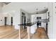 Open floor plan with hardwood floors, high ceilings, stainless steel appliances, and a kitchen island at 1836 Danny Ct, Matthews, NC 28105