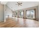 Spacious living room with hardwood floors, ceiling fan, and natural light from the many windows at 1836 Danny Ct, Matthews, NC 28105